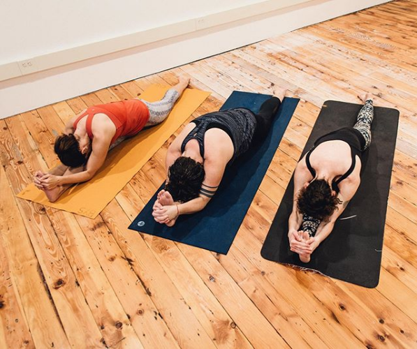 The people in yoga positions at Sea Level Hot Yoga